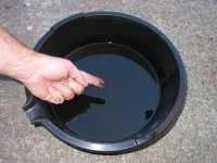 Rub the cooled oil with your finger to check for metal particles and grit that could indicate excessive engine wear.