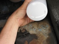 Replace the filter, carefully twisting it clockwise on the center shaft, tightening it by hand only.