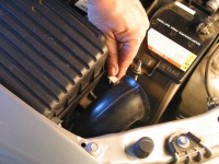 Air filters typically are found in a plastic box at one side of the engine or the other. To open, remove the latch or screws.