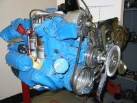 Cutaway look inside a car engine shows cylinders and pistons.