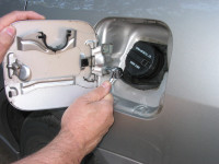 To find matching touch-up paint, remove the fuel fill cover (typically two bolts or screws) and take it with you to an auto paint supply store.